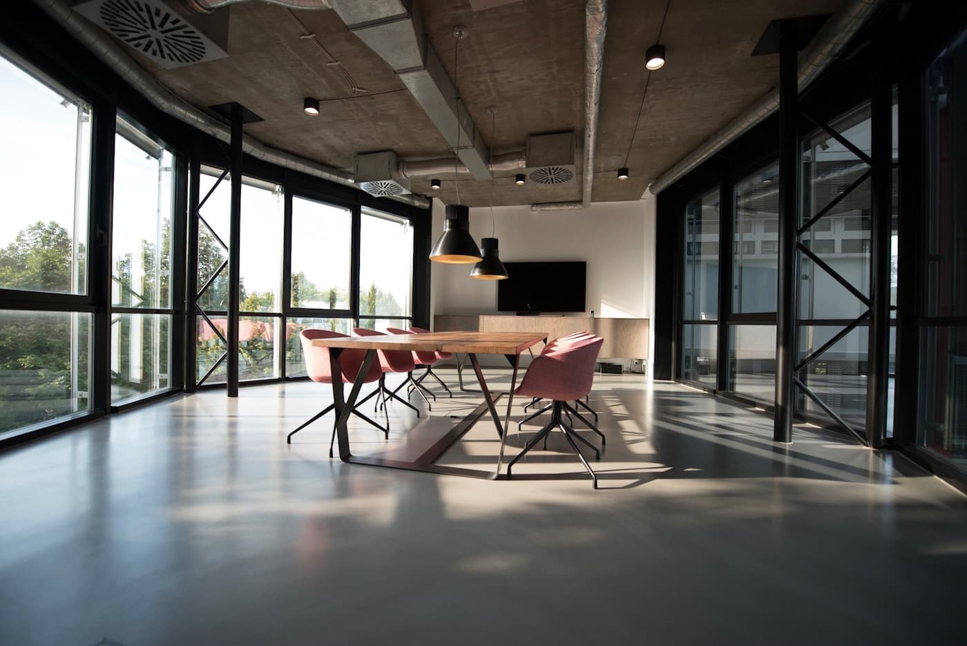 Bright commercial workspace with shared tables and plants